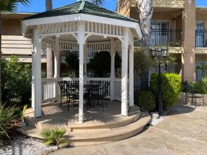 a white gazebo with chairs and a table at Studio 6 Vallejo CA Napa Valley in Vallejo