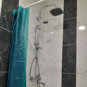 a shower with a glass door in a bathroom at Lovely Apartment in City Center in Batumi