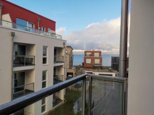 an apartment balcony with a view of the ocean at FeWo auf der Ostsee in Olpenitz