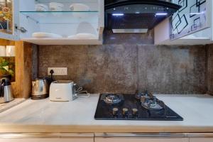 a kitchen with a stove top in a kitchen at Avanti Tenantry- Gurugram in Gurgaon