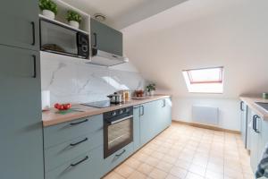 a kitchen with a sink and a stove top oven at Private & Comfortable Apartments in Puttelange-aux-Lacs