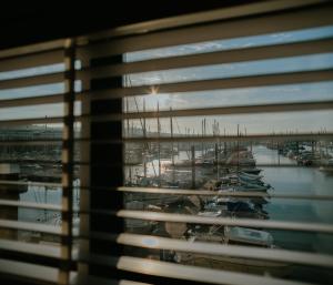 a view from a window of a marina with boats at Tiny Floating Home with Marina Views in Brighton & Hove