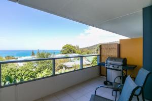 a balcony with a grill and a view of the ocean at Lorne Chalet Apartment 40 in Lorne