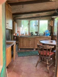 eine Küche mit einem Tisch und einem Stuhl darin in der Unterkunft Bungalow im Wald am See - Biberspur in Zieko