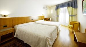 a hotel room with two beds and a window at Hotel Florida in Arteixo +16 photos