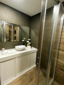 a bathroom with a sink and a shower at Island Princess Resort & Spa Boracay in Boracay