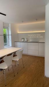 a kitchen with a table and chairs in a room at Moselfreude in Cochem