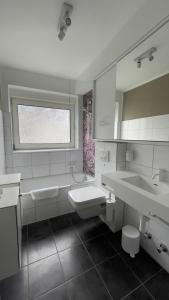 a white bathroom with two sinks and a mirror at Moselfreude in Cochem
