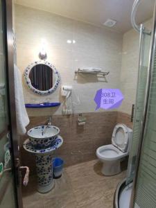 a bathroom with a sink and a toilet at Great Wall hotel in Tbilisi City