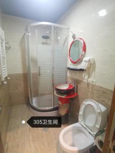 a bathroom with a toilet and a shower with a mirror at Great Wall hotel in Tbilisi City