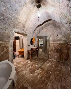 a bathroom with a shower and a bath tub at ROCA CAPPADOCIA in Ürgüp
