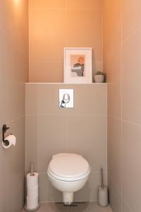 a bathroom with a white toilet in a room at Nice bright apartment near the sea and the marina in Ostend +17 photos