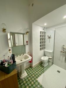 a bathroom with a sink and a toilet and a shower at Appartement Haussmannien rue piétonne Opéra in Marseille