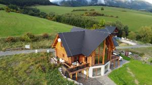 an overhead view of a log home with a black roof at Chalet Liptov in Ižipovce