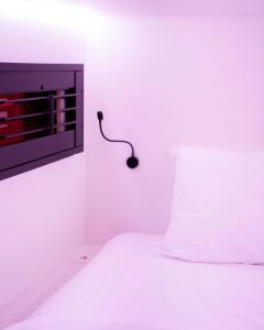 a bedroom with a bed with a mouse on the wall at THIS HO(S)TEL in Amsterdam