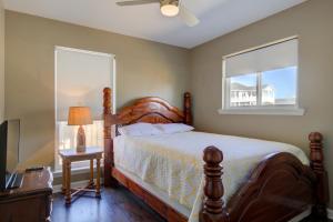 a bedroom with a bed and a window at Living the Dream in Surf City