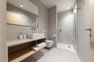 a bathroom with a sink and a toilet and a shower at Solis Apartments in Lana