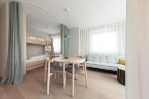 a small room with a table and a bed at Solis Apartments in Lana