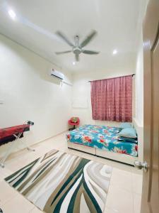 a bedroom with a bed and a ceiling fan at Rawyna homestay segamat in Segamat