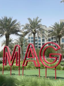 a large red sign that says miami in front of palm trees at MAG 565, Boulevard, Dubai South, Dubai in Dubai
