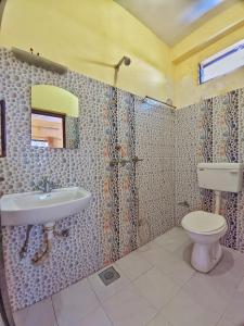 a bathroom with a sink and a toilet at Lumbini Garden Lodge in Rummindei