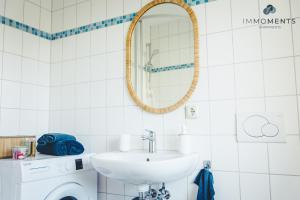 a bathroom with a sink and a mirror at Studio Apartment im Zentrum in Magdeburg +32 photos