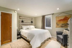 a bedroom with a bed and a chair and a window at Hot Tub! Pets Ok! Perfect Estes Park Getaway, Walk to Town 3 Kings! in Estes Park +62 photos