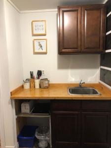 a kitchen with a sink and a counter top at Greenside Motel in Saint Andrews