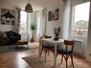 a living room with a white table and chairs at Gevrey-Chambertin au coeur du village in Gevrey-Chambertin