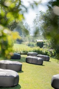 a row of cement objects sitting on the grass at Rooms Kronblick in San Lorenzo di Sebato