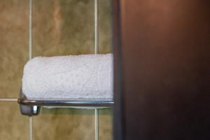 a towel hanging on a towel rack in a bathroom at Rooms Kronblick in San Lorenzo di Sebato