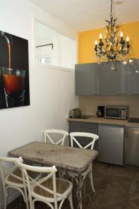 a kitchen with a table and chairs in a kitchen at Appartement Cannes rue Marceau in Cannes