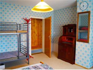 a bedroom with a bunk bed and a clock on the wall at CASA-Li old Farmhouse in Tengen