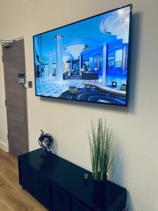 a flat screen tv hanging on a wall at Perfect 1 Bed Apartment - Central with Parking, WiFi, TV, Desk in Peterborough +19 photos