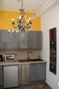 a kitchen with a sink and a chandelier at Appartement Cannes rue Marceau in Cannes