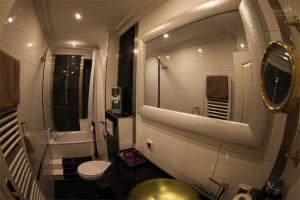 a bathroom with a sink and a toilet and a mirror at Golden Apartments in Essen +113 photos