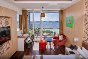 a living room with a view of the ocean at Summer Beach Maldives in Male City