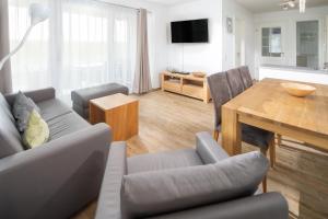 a living room with a couch and a table at Sonnenterrasse in Juist