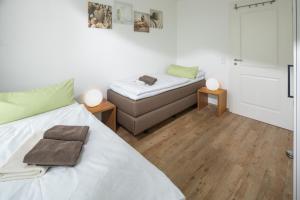 a bedroom with a bed and a desk and a door at Sonnenterrasse in Juist