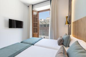 BiBo Suites San Agustín客房内的一张或多张床位