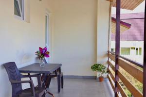 a table and chairs on the balcony of a house at Gio Hotel in Gudauri