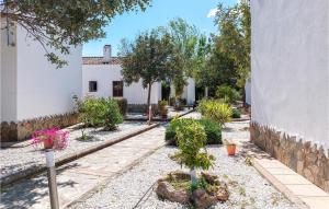 a garden with trees and plants in front of a building at Beautiful Home In El Coronil With Wifi in El Coronil +12 photos