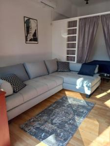a living room with a couch and a rug at City center, peaceful, with free parking in Varaždin
