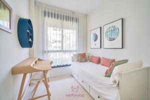 a living room with a couch and a window at weforyou Las Nereidas de Los Álamos 3 bedrooms and PARKING in Torremolinos