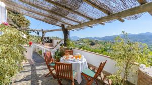 a table on the balcony of a house with a view at Casa Guajar Monda by Ruralidays in Monda