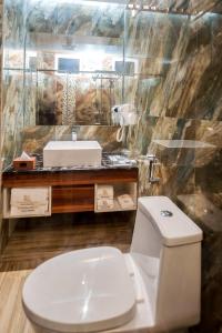 a bathroom with a white toilet and a sink at Summer Beach Maldives in Male City