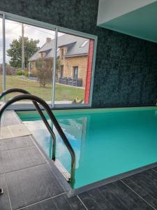 a swimming pool with a view of a house at Gîte Avalon - Closeries du Golfe in Theix