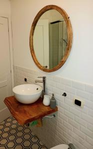 a bathroom with a white sink and a mirror at RoRo Roma in Rome