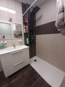 ein Badezimmer mit einem weißen Waschbecken und einem Spiegel in der Unterkunft Angel in Zamora