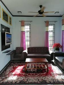 a living room with a couch and a coffee table at SMART 2.0 Homestay Pantai Kemayang Bachok in Bachok